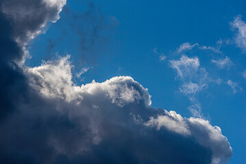 The sunlit edge of a dark cloud in the autumn sky.