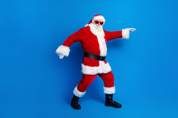 Full size photo of pensioner senior man sneak go deliver present dressed stylish santa claus costume coat isolated on blue color background