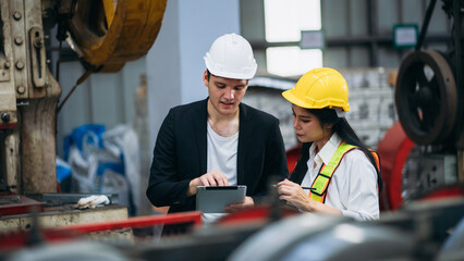 Industrial worker inspecting machine at factory machines. Technician working in the metal sheet company. Foreman checking Material or Machine.