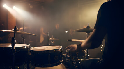 Back View of drummer plays drums during a show. Band on a stage club high resolution
