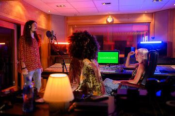 A singer is recording a song in a music studio.