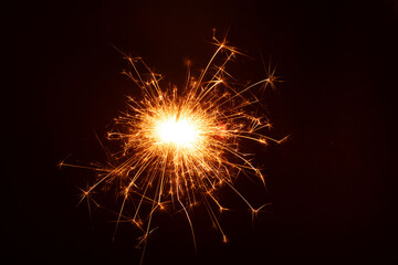 photography the bright glow of a sparkler in the dark, creating a merry and celebratory atmosphere....