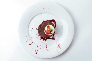 chocolate dessert with ice cream on a plate on a white background