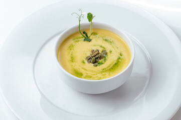 pumpkin soup in a plate on a white background