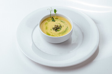 pumpkin soup in a plate on a white background