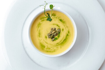 pumpkin soup in a plate on a white background