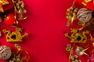 Chinese New Year 2024 greeting card. Bright red asian year of the dragon background with golden dragon figurine, Chinese lanterns, traditional jewelry, gifts, coins, cookies with wishes, copy space