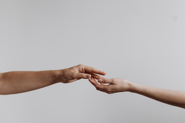 Hands touching each other isolated on grey background. Concept of human relation, community,...