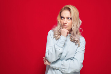 Doubt young woman looking to side, thinking with frowned face expression, isolated on white background