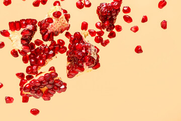 Flying fresh pomegranates with seeds on yellow background