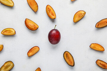 Fresh ripe plums on white background