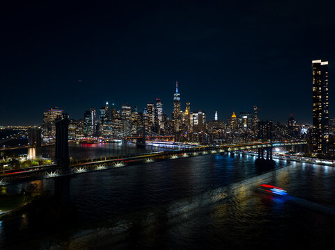 New York bridge near me. Aerial night drone photo with city lights and river