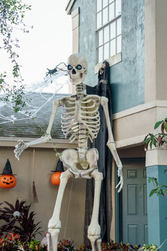Large skelaton at a house for Halloween with digital eyes