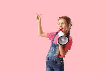 Little girl with megaphone pointing at something on pink background - obrazy, fototapety, plakaty