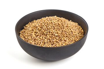 Barley groats in bowl, isolated on white background.