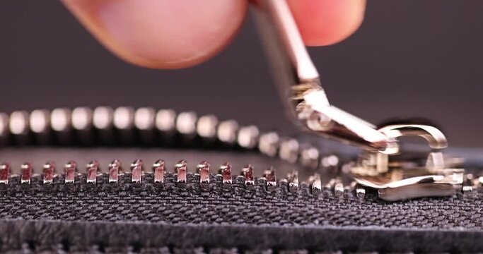 metal zipper on a black leather product, zipper on a black women's handbag close-up