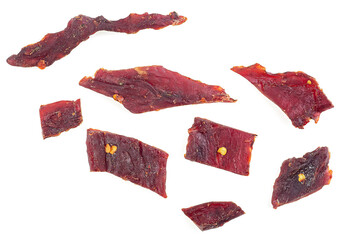 Beef jerky pieces isolated on a white background, top view. Portion of dried beef meet.