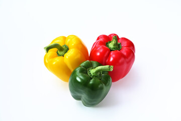 three sweet peppers red, yellow and green on a white background