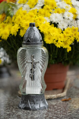 Lantern and flowers on the grave on All Saints' Day