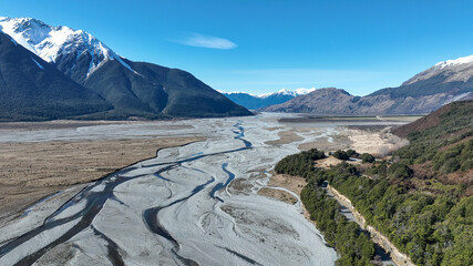 Aerial photography of the braided river with very little water flowing through the alpine Arthurs Pass