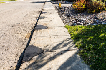 Concrete sidewalk repair with asphalt patching