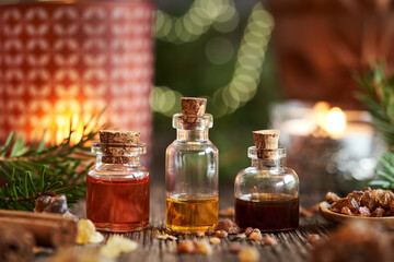 Christmas selection of essential oils with frankincense, myrrh, cinnamon and spruce