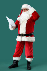Confused Santa Claus with letters on green background
