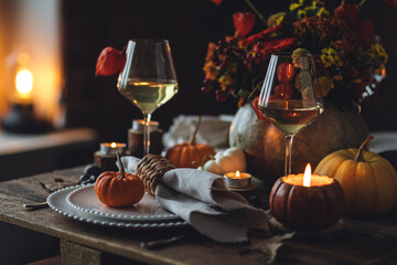 Beautiful elegant table setting for candlelight Thanksgiving Day dinner or Halloween party at home....