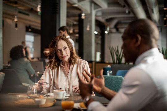 Mature woman having meeting with business partner in hotel restaurant