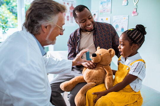 Doctor entertaining his little patient at the clinic