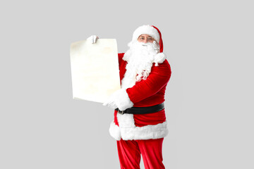Santa Claus with blank letter on grey background
