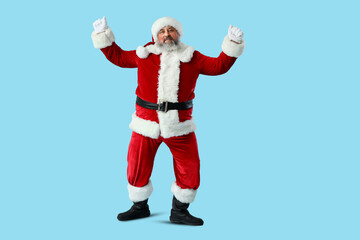 Dancing Santa Claus on blue background
