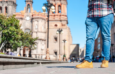 Young tourist view from chest to feet in San Luis Potosi downtown in Mexico, low angle shot, copy...