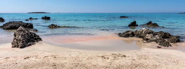 Tuinposter Elafonissi Strand, Kreta, Griekenland Pink sand beach, the famous Elafonisi (or Elafonissi). Crete island in Greece. Banner of a paradise with incredible colors. Rocks and transparent water with sand clearly visible pink reflections.