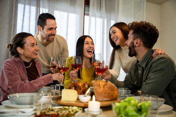 Happy people having fun eating and drinking together - Family having dinner toasting wine glasses...