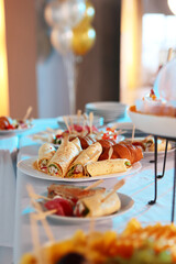 Catering buffet table with snacks and appetizers. Various light snacks. Food for a buffet table in...