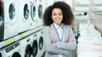 Portrait smiling female sales consultant Expert standing in a home appliance store looking at camera. African american employee black woman worker seller smiles. saleswoman manager vendor at work 