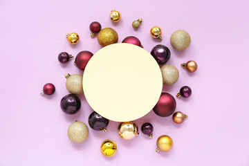 Blank card and Christmas balls on lilac background