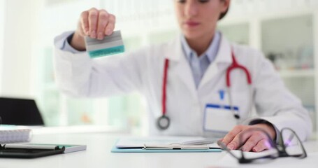 Doctor therapist puts stamp on important medical documents closeup