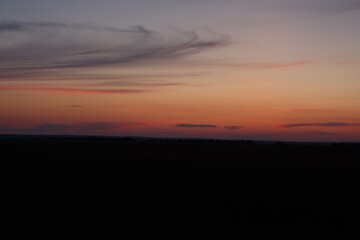 Fototapeta na wymiar Dark blue Sky Horizon with Sunset Clouds