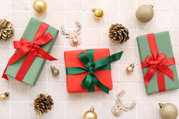 Christmas gift boxes and beautiful decorations on beige tile background
