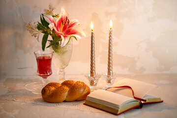Challah bread, shabbat wine and candles on light background. Traditional Jewish Shabbat ritual....