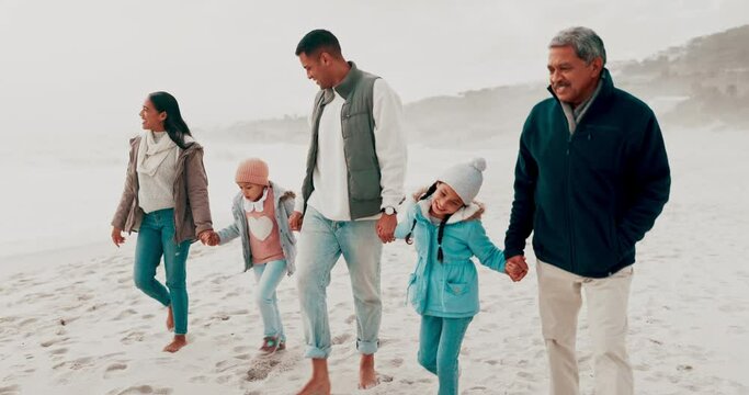 Happy family, holding hands and beach walk on vacation, travel and holiday freedom together. Love, bond and kids with parents and grandpa walking on ocean trip and conversation with a smile outdoor