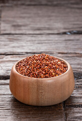 Raw red quinoa seeds in a bowl - Chenopodium quinoa