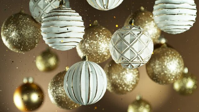 Christmas Decoration with Colored Shiny Balls and Glitters Falling Down. Beautiful Holidays Slow Motion Footage. Filmed on High Speed Cinema Camera, 1000 fps.