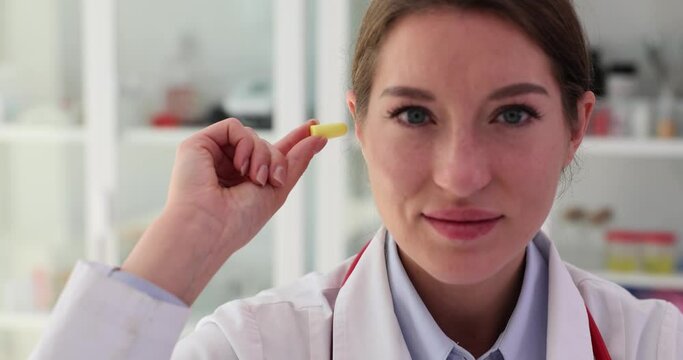 Female ENT doctor plugs earplugs in clinic