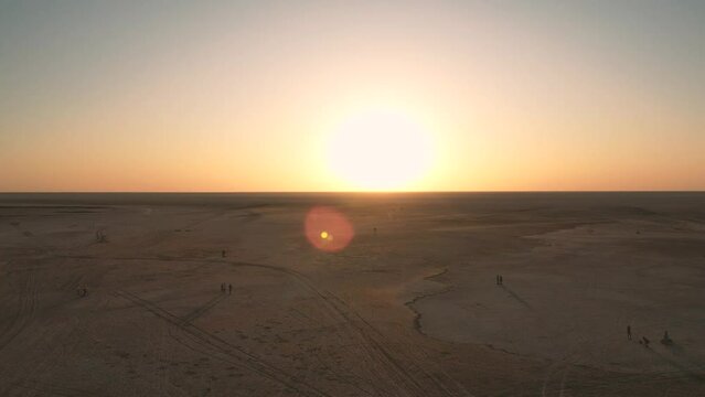 Low drone flight in a salt desert with a sunset. Drone flies forward at low level. General plane