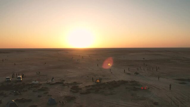 Low drone flight in a salt desert with a sunset. Drone flies forward at low level. General plane