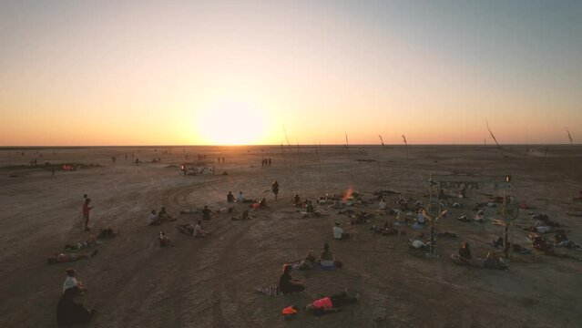 Low drone flight in a salt desert with a sunset. Drone flies forward at low level. General plane