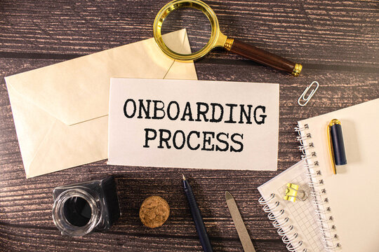 Closeup on businessman holding a card with ONBOARDING PROCESS message, business concept image